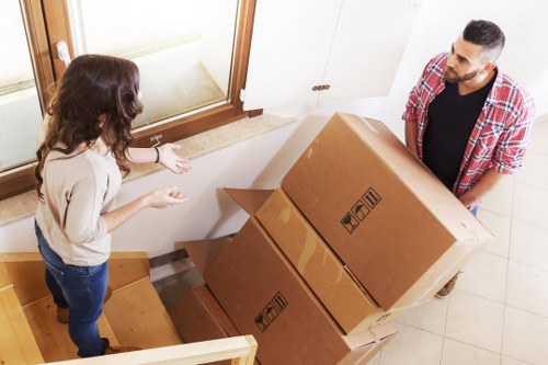 Boxes and household items being loaded into a removal van