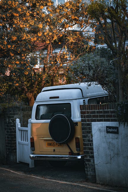 Close-up view of a parking space on a tarmac driveway with the number '22' painted in white, showing signs of wear and slight fading. The space is adjacent to other marked parking areas with partially visible lines and numbers. The scene is outdoors, with natural lighting casting slight shadows on the textured surface. This setting is typical of a residential or city parking lot used during home relocations or furniture transport. The image reflects the environment where Man with Van Rainham might load or unload belongings for house removals on Wennington Road, highlighting practical aspects of moving logistics such as parking arrangements and access points.